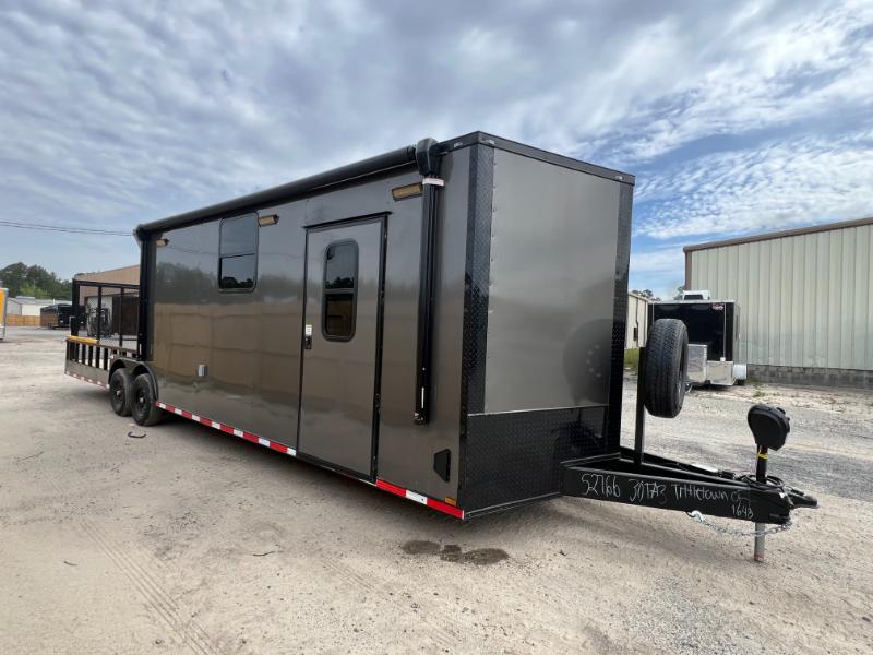 Hybrid Enclosed Trailer 8.5x30TA 1 A gray 8.5x30TA hybrid enclosed trailer, shown from a front-side angle to highlight its dual-purpose design.