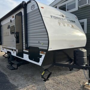 A compact and lightweight 2025 Palomino Puma Camping Edition 16BHCE travel trailer, featuring a white and gray exterior. The RV has a single axle, a front queen bed, and rear bunks, making it ideal for small families.