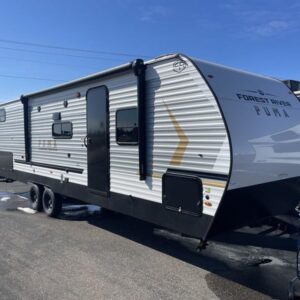 A large 2025 Palomino Puma Camping Edition 304BHCE travel trailer, a bunkhouse model with a white exterior and graphics. The RV features multiple slide-outs, an outdoor kitchen, and a power awning.