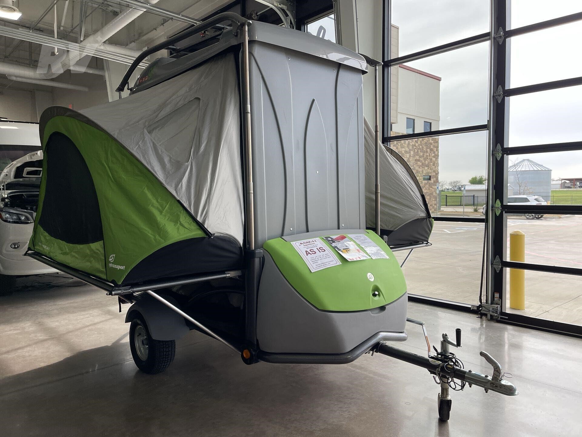 2017 SYLVAN SPORT GO 1 A 2017 Sylvan Sport GO, a versatile and lightweight pop-up camping trailer. The trailer is shown in its compact, travel-ready state, with a streamlined, gray-and-green design. It has a cargo rack on top and is low-profile for easy towing.