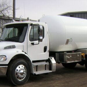 A Blueline BX Bobtail propane delivery truck, featuring a large cylindrical tank mounted on a truck chassis. The tank is black or a dark color, with a hose reel and other delivery equipment visible at the rear.