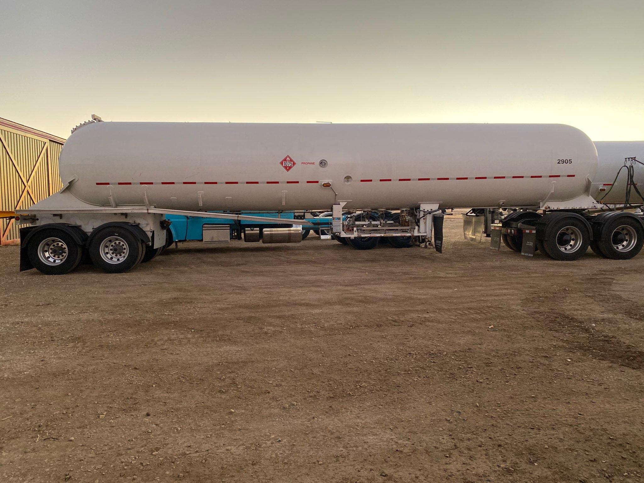 Buy 11600 Gallon Industrial Gas Tank Trailer Online MC-331 LPG LIQUID TANKER IN STOCK 1 Polar 11600-gallon horizontal propane tank with a white exterior. The tank is cylindrical with rounded ends and is shown outdoors on a sunny day.